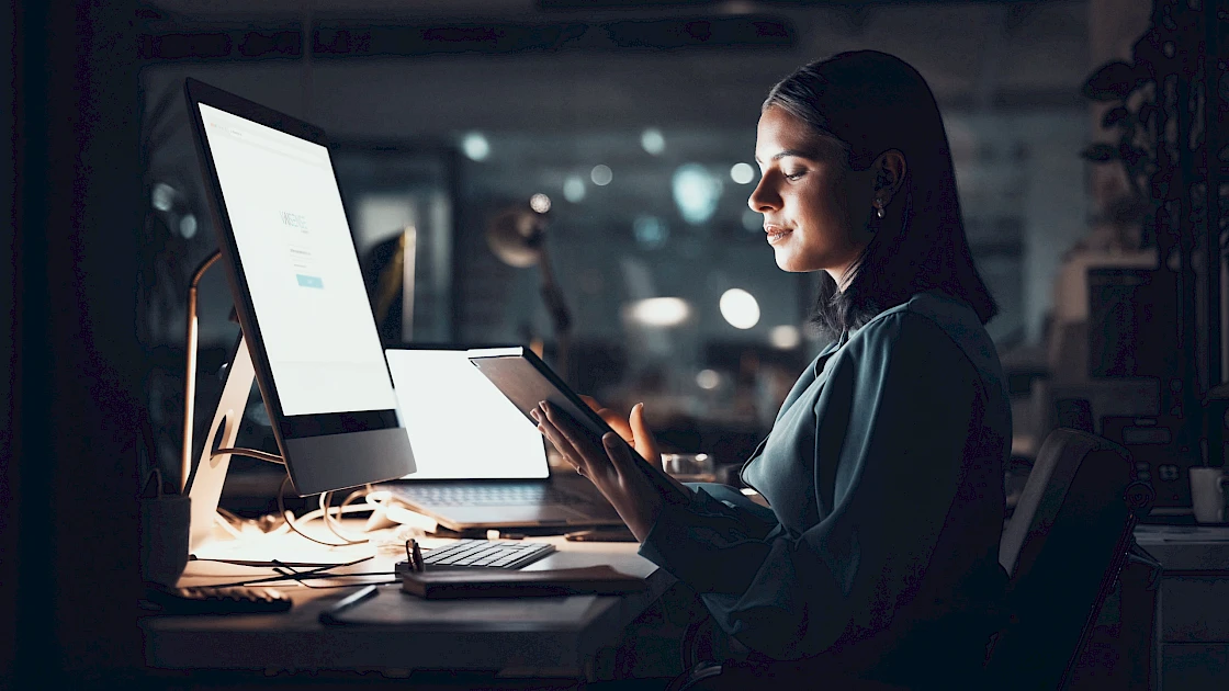 A woman at her computer utilizing VAISense AI tools.