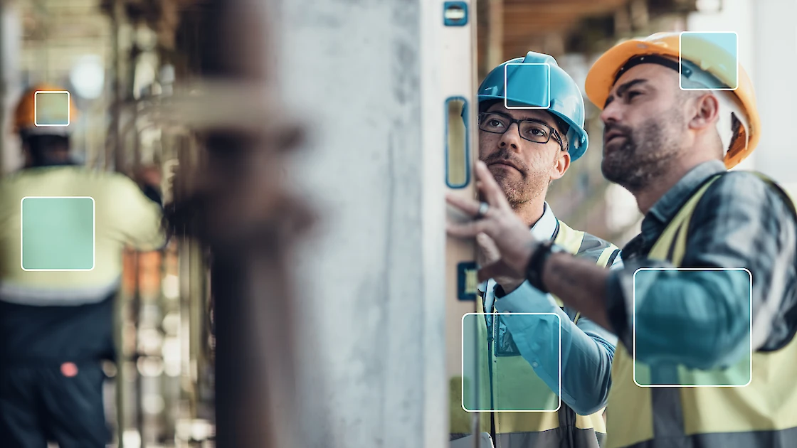Construction workers being tracked for compliance with safety requirements.